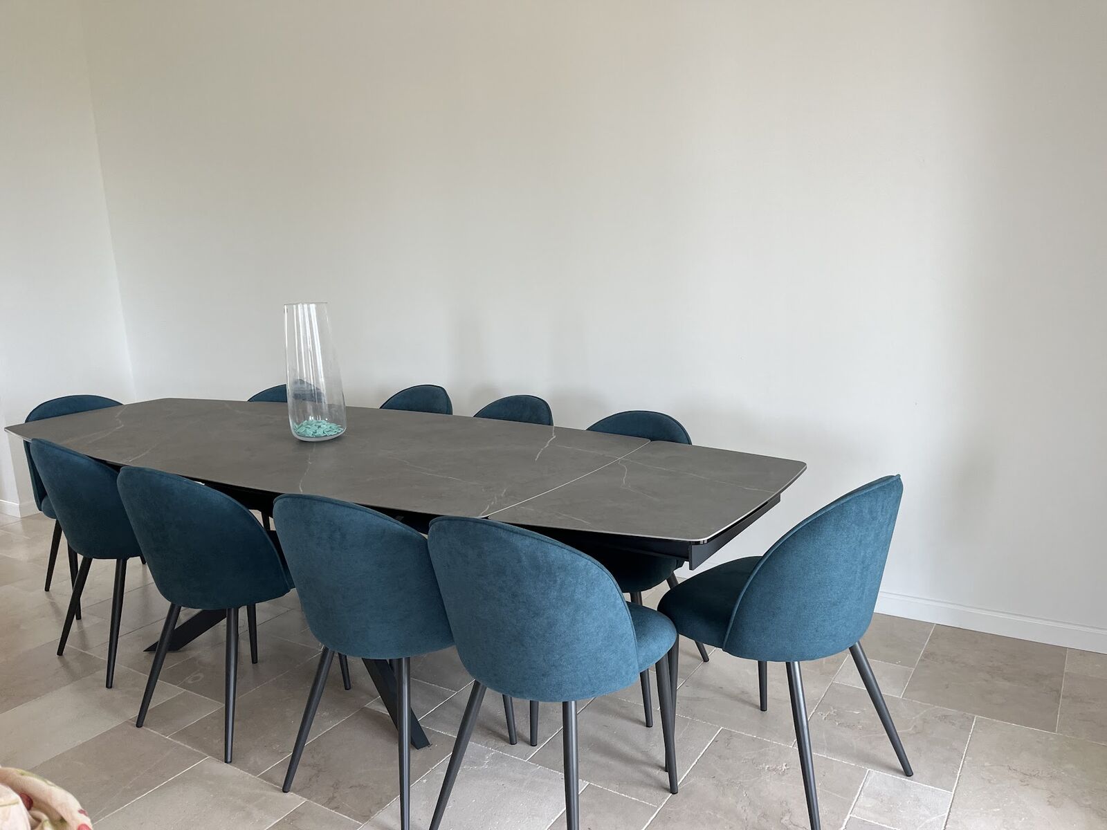 Dining room with long table and deep blue chairs