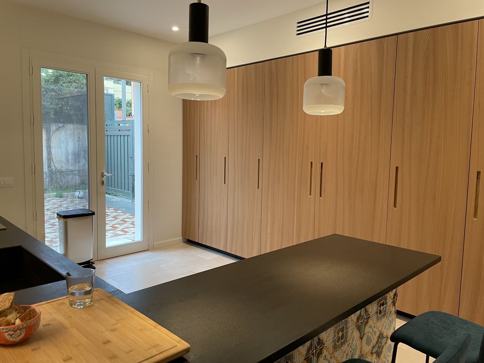 Fitted kitchen with timber cabinetry and long dark island