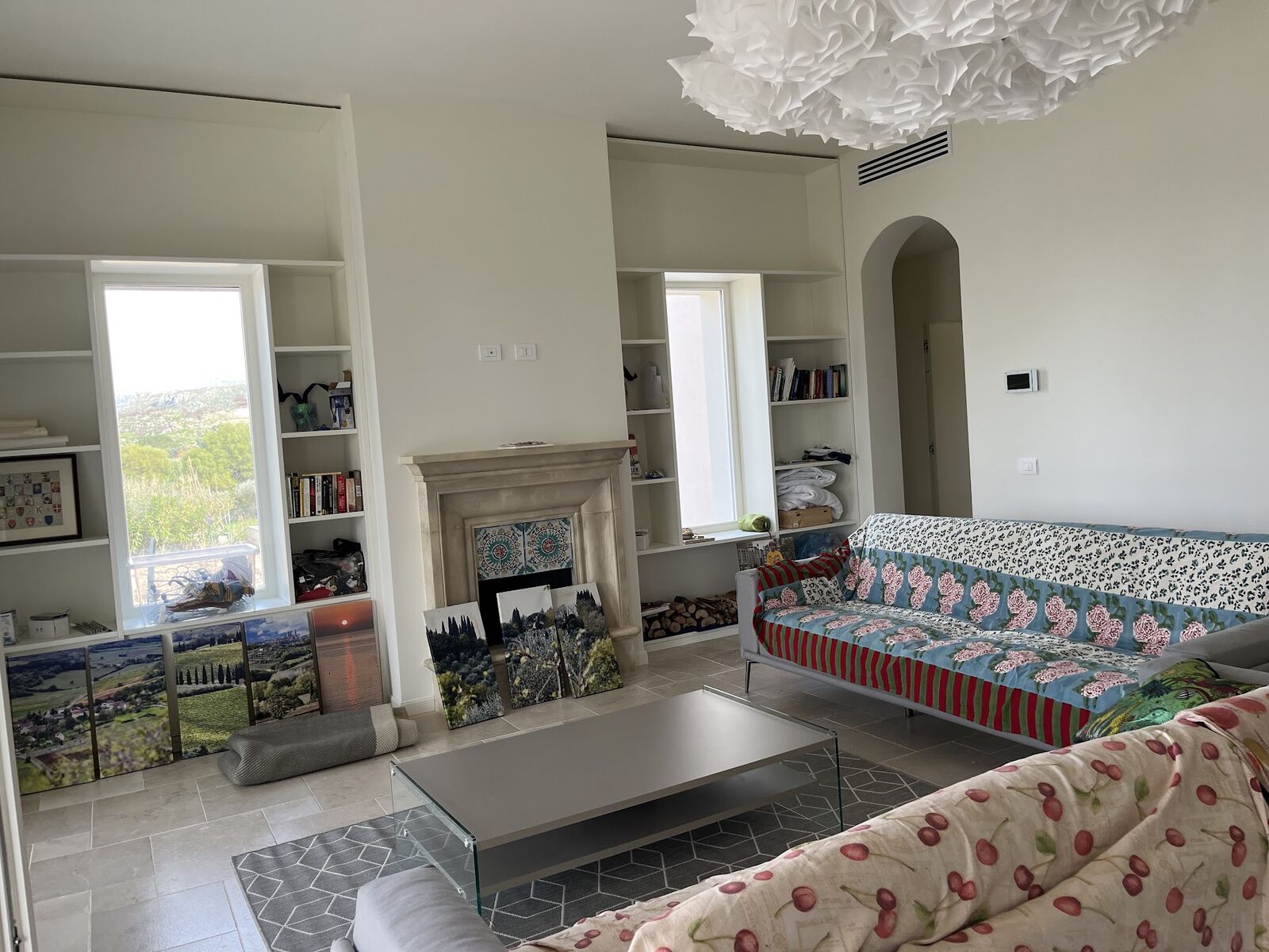 Living room with fireplace and patterned Sicilian sofa