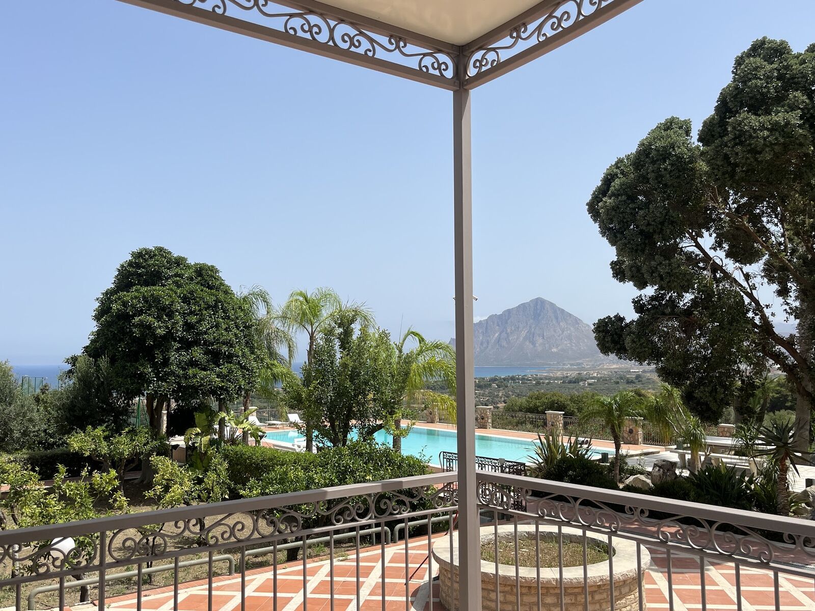 View from the shaded terrace over the pool toward Monte Cofano